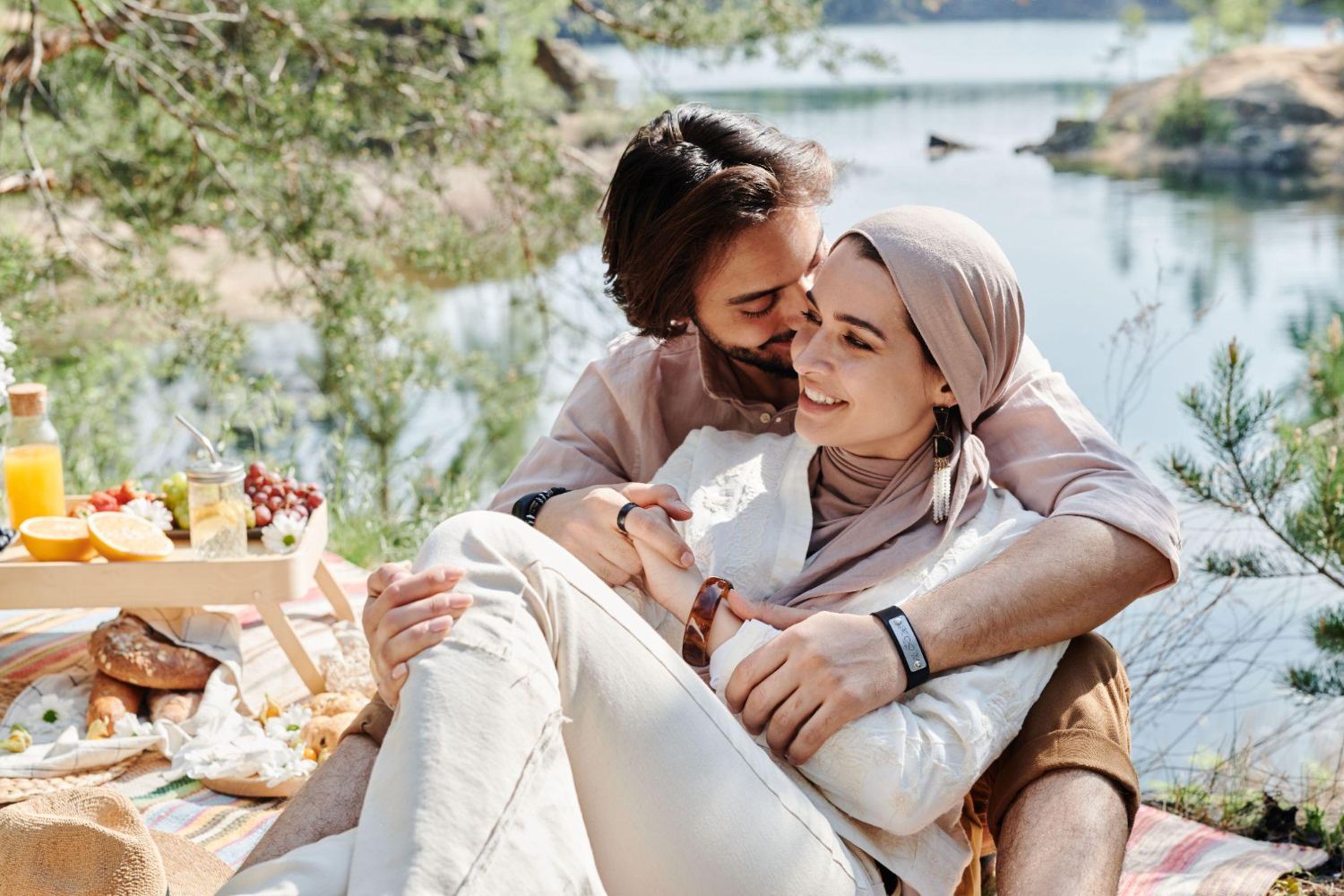 Two women picnicking by the water