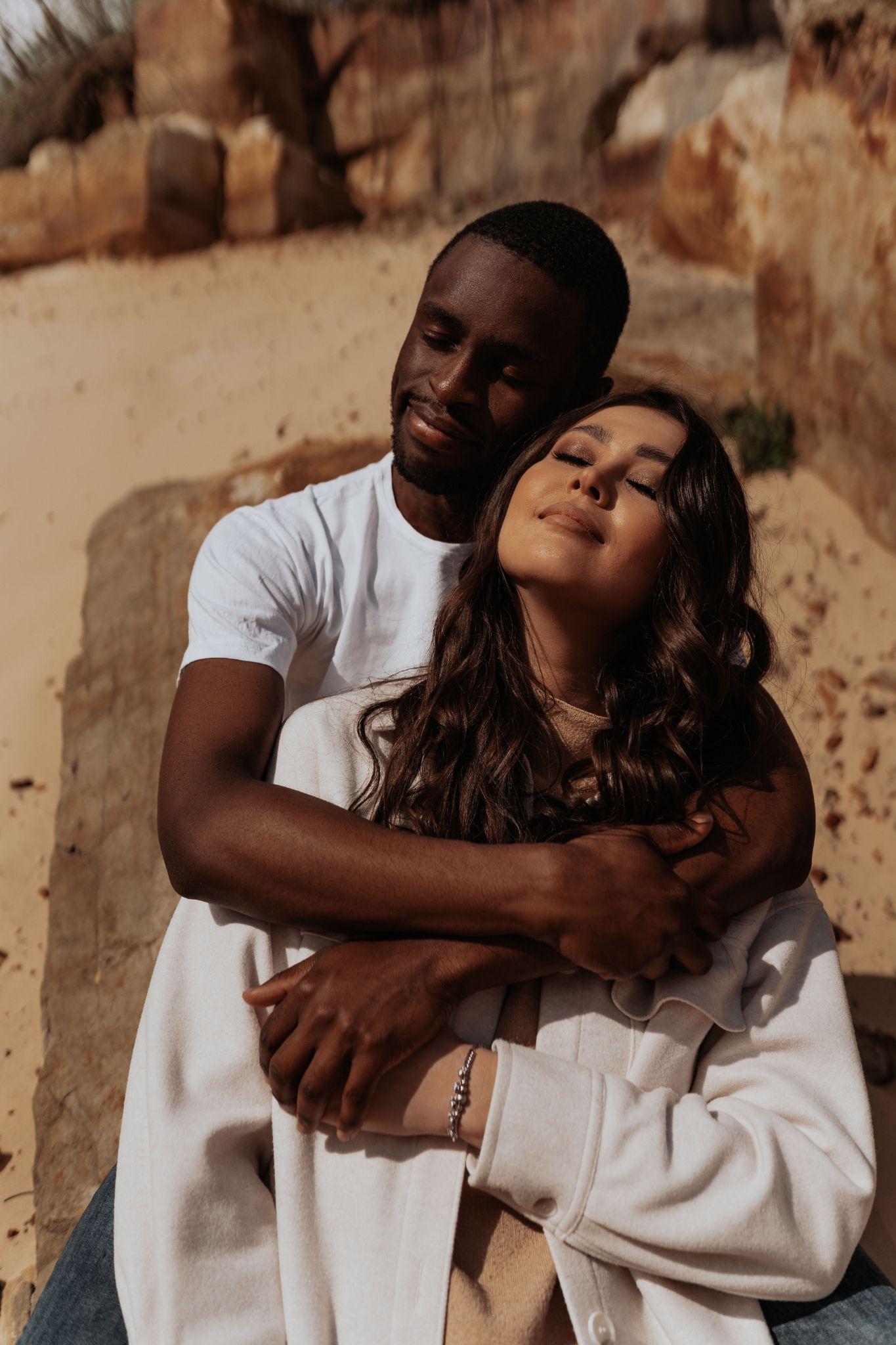 A couple embracing in warm desert light