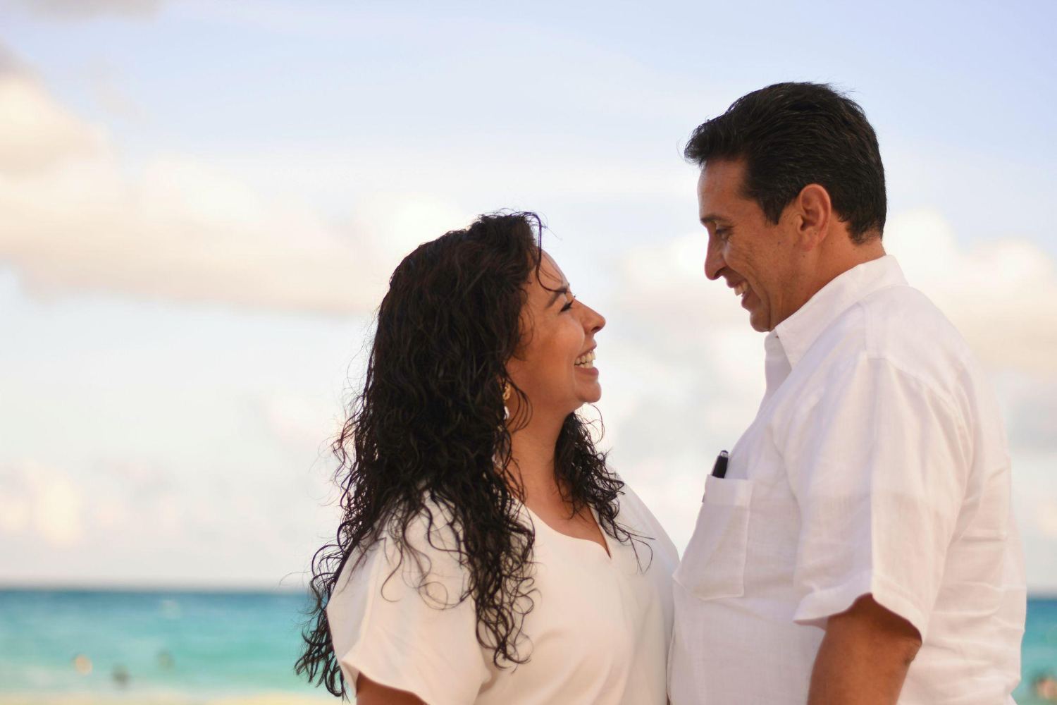Two people facing each other at the shore